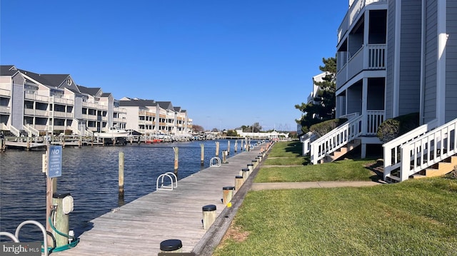 dock area featuring a water view and a yard