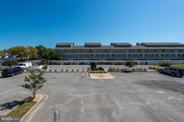 view of property with uncovered parking and a residential view