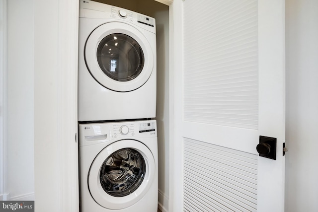 laundry area with stacked washer / drying machine