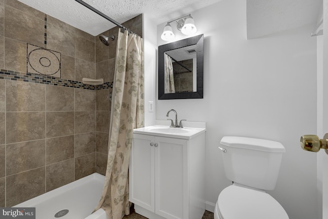 bathroom with tiled shower, a textured ceiling, toilet, and vanity