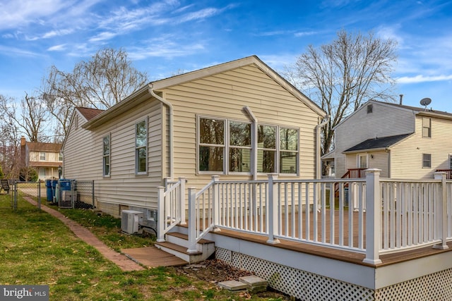 back of house featuring a gate, fence, and a wooden deck