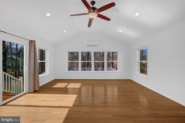 interior space with lofted ceiling, recessed lighting, wood finished floors, and baseboards