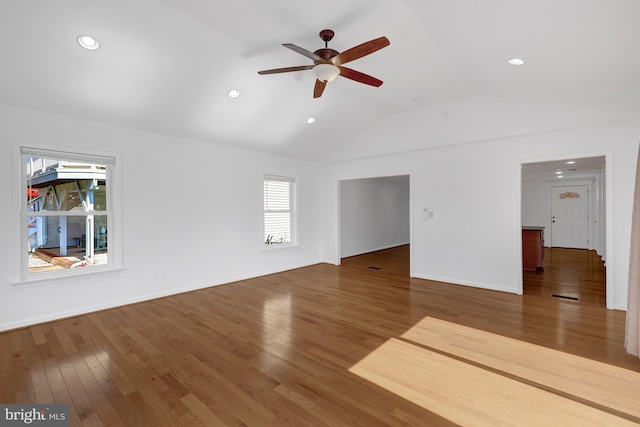 unfurnished living room with wood finished floors, baseboards, lofted ceiling, recessed lighting, and ceiling fan