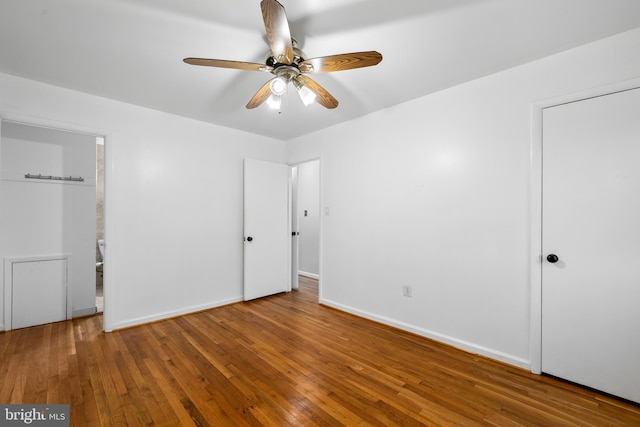 unfurnished bedroom with wood-type flooring and baseboards