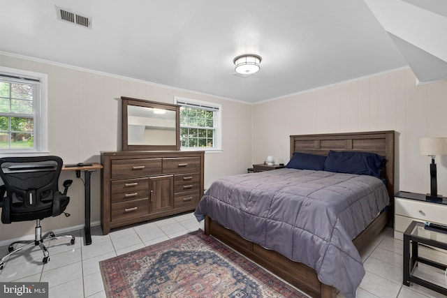 bedroom featuring crown molding, visible vents, and light tile patterned floors