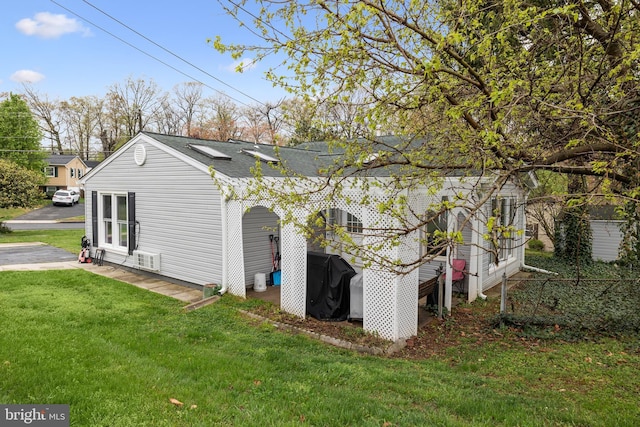 view of property exterior featuring a yard and a shingled roof