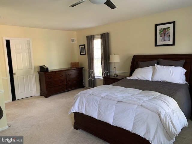 bedroom with light carpet, ceiling fan, and baseboards