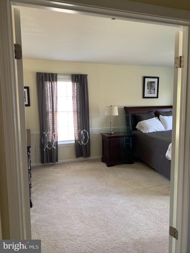 carpeted bedroom with baseboards