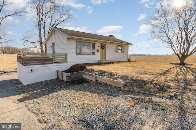 view of front of house featuring a chimney