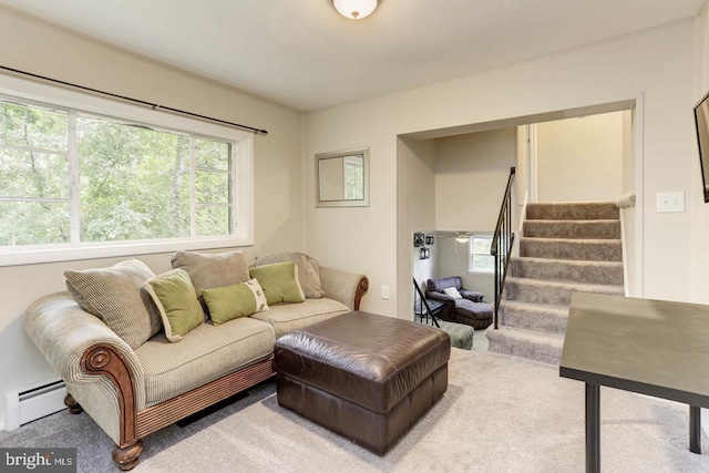 living room featuring baseboard heating, plenty of natural light, and carpet floors