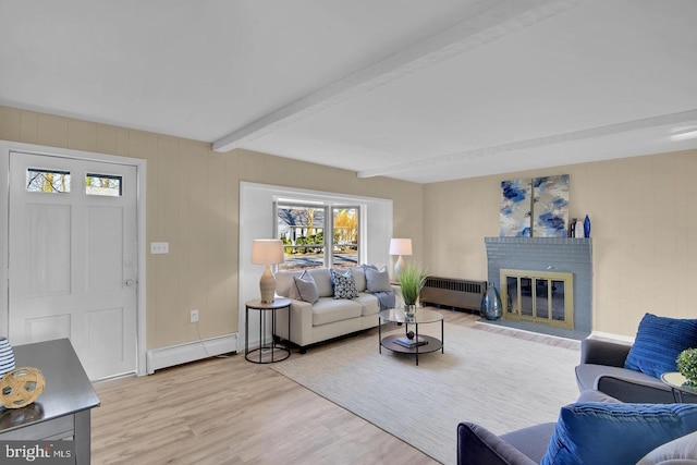 living room featuring a brick fireplace, light hardwood / wood-style flooring, a baseboard radiator, radiator heating unit, and beamed ceiling