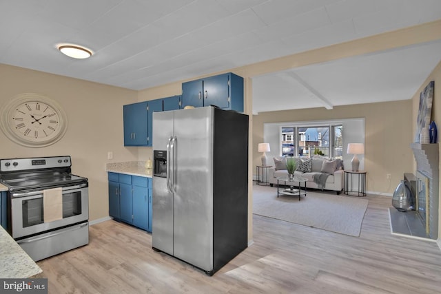 kitchen featuring blue cabinetry, stainless steel appliances, and light wood-type flooring