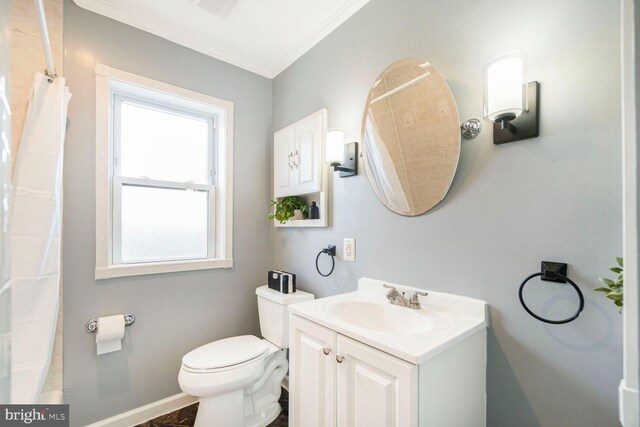 full bathroom with toilet, baseboards, ornamental molding, and vanity