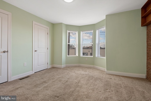 spare room featuring light colored carpet