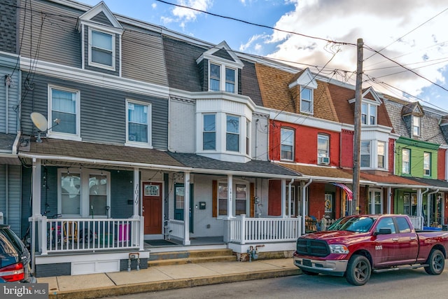 townhome / multi-family property featuring covered porch