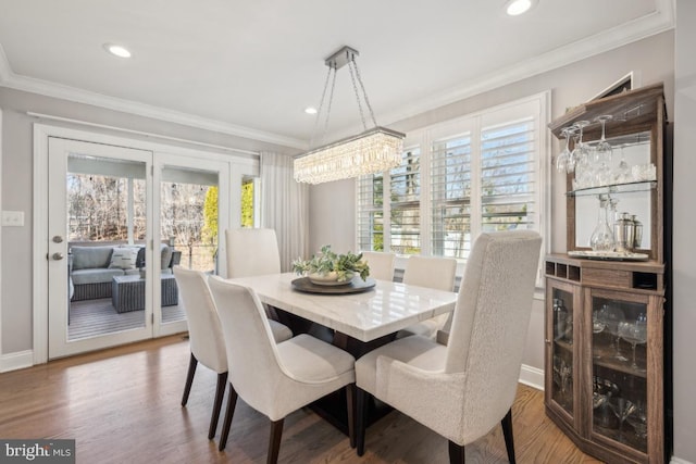 dining room featuring recessed lighting, crown molding, and wood finished floors