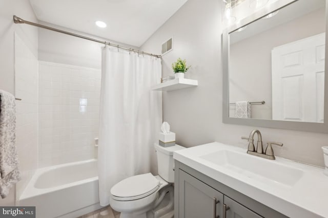 bathroom with shower / tub combo, visible vents, vanity, and toilet