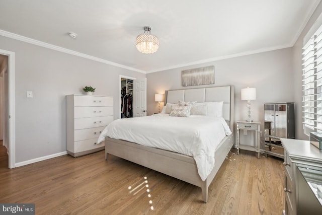 bedroom with light wood-type flooring, baseboards, and ornamental molding