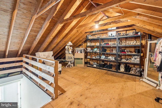 unfinished attic with an upstairs landing