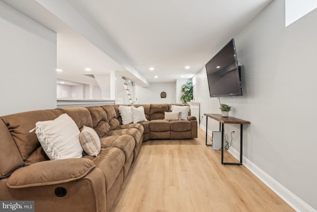 living room featuring light wood-type flooring, baseboards, and recessed lighting