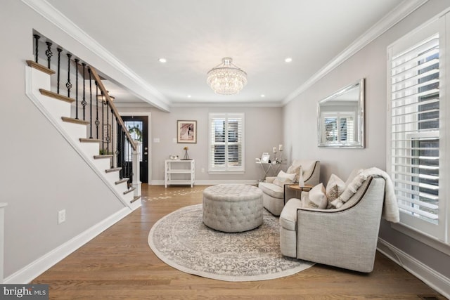 sitting room featuring ornamental molding, a wealth of natural light, wood finished floors, and stairs