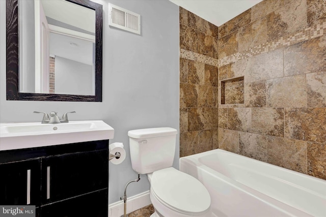 full bathroom featuring vanity, tiled shower / bath combo, and toilet