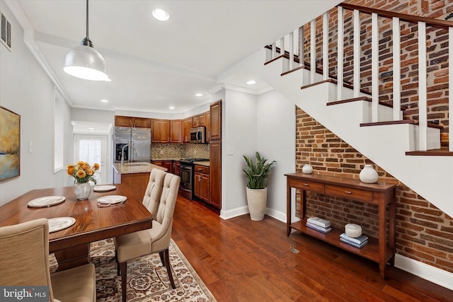 dining space featuring ornamental molding, dark hardwood / wood-style floors, and sink