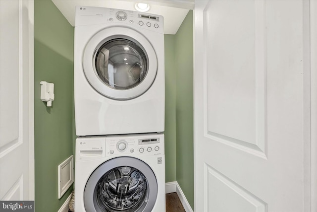 washroom featuring stacked washing maching and dryer