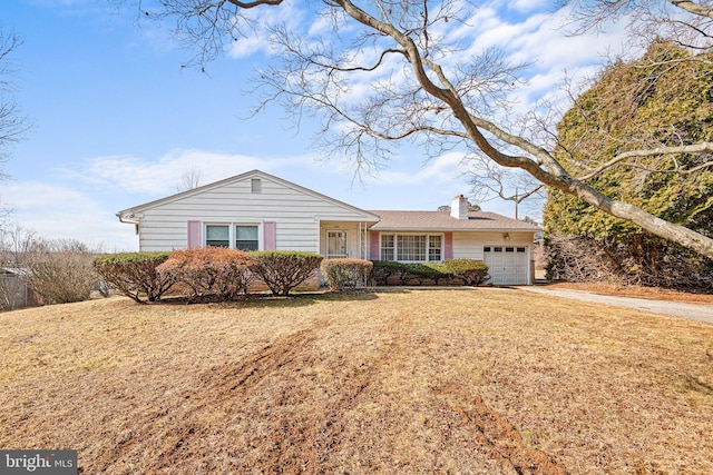 ranch-style house featuring a garage and a front lawn