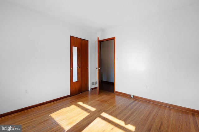 empty room featuring hardwood / wood-style flooring