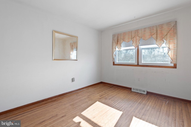 unfurnished room featuring hardwood / wood-style flooring