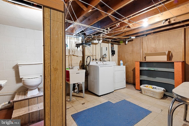 basement featuring sink and washer and dryer