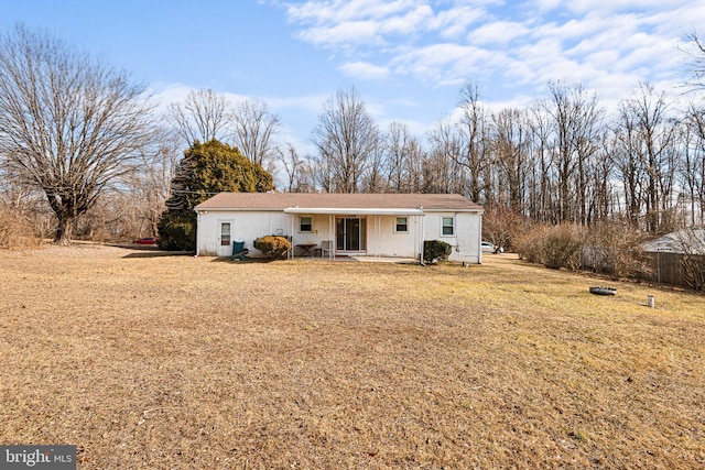 back of property with a lawn