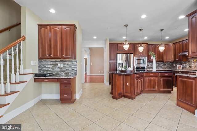 kitchen featuring dark stone countertops, hanging light fixtures, light tile patterned floors, and appliances with stainless steel finishes