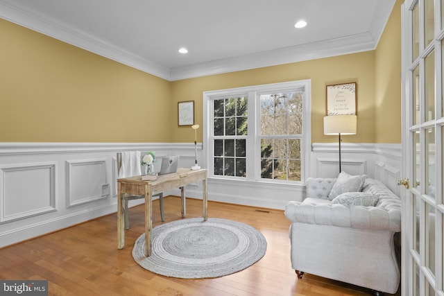 office area with ornamental molding and light hardwood / wood-style flooring