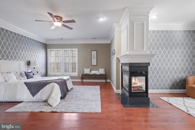 bedroom with crown molding, a multi sided fireplace, ceiling fan, and dark wood-type flooring