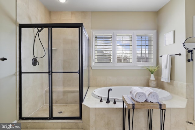 bathroom with separate shower and tub