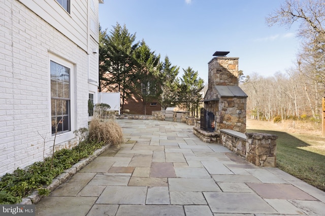 view of patio / terrace with an outdoor stone fireplace