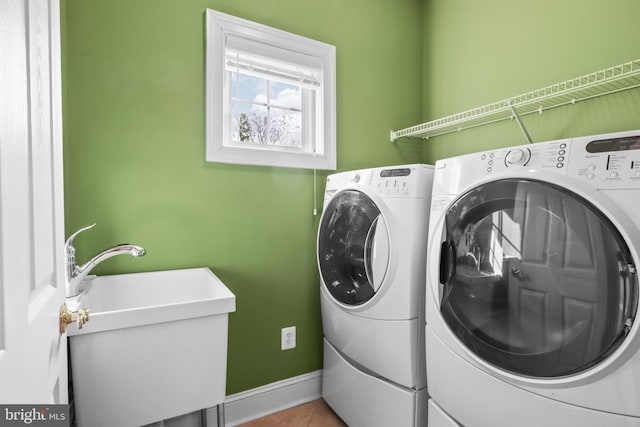 laundry room featuring sink, washing machine and clothes dryer, and tile patterned floors