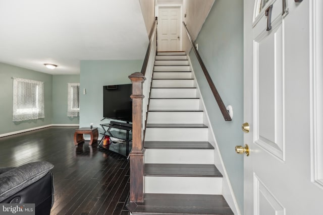 stairs featuring wood finished floors and baseboards