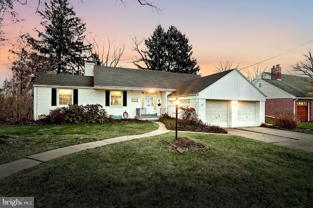 ranch-style house featuring a yard and a garage