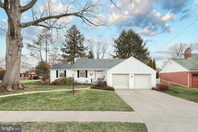 single story home featuring a garage and a front lawn