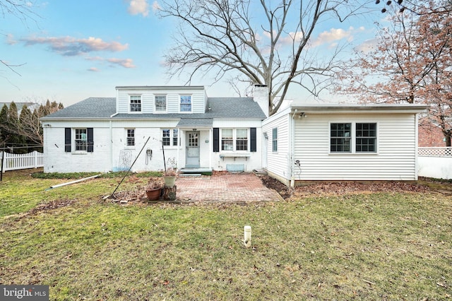 view of front of house with a patio area and a front lawn