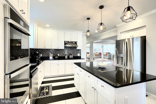 kitchen featuring appliances with stainless steel finishes, a kitchen island, pendant lighting, and white cabinetry