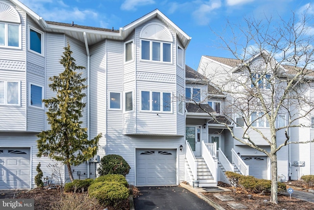 view of property featuring a garage and driveway