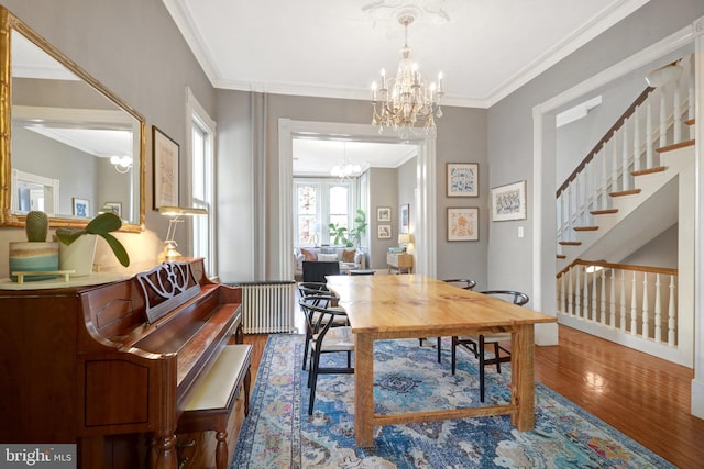 office with crown molding, radiator heating unit, wood finished floors, and a chandelier