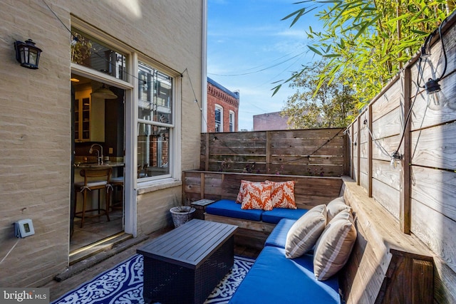 view of patio with an outdoor living space and a fenced backyard