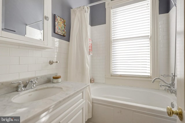 bathroom with shower / bath combination with curtain, tile walls, and vanity