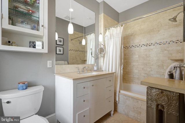 bathroom featuring visible vents, toilet, tiled shower / bath combo, tile patterned flooring, and vanity