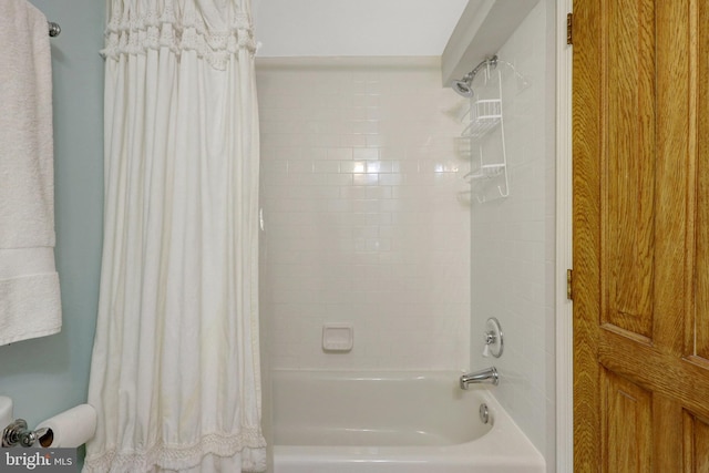 bathroom with shower / bath combo with shower curtain